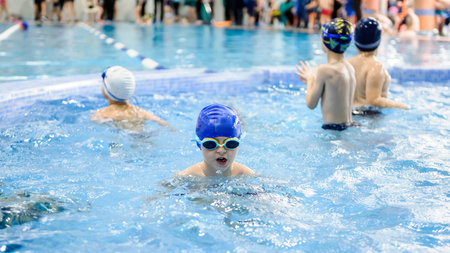 a 6-year boy swims in a swimming pool for kids