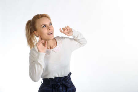 20-years blond girl in white blouse and blue skirt on white backgroundの写真素材
