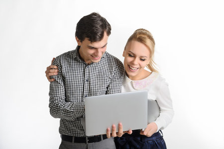 business partners: a blonde woman in a formal outfit and a brunet man in a grey outfit working on...