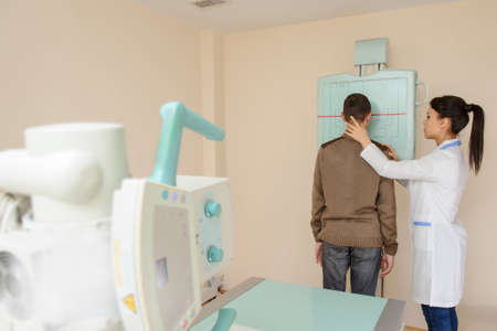 Female doctor preparing the patient for paranasal sinuses x-ray procedure in the radiologist's cabinetの写真素材