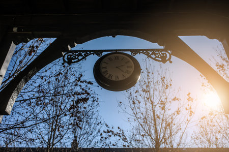 vintage decorated clock hanged at the entrance of a hotel in classic style