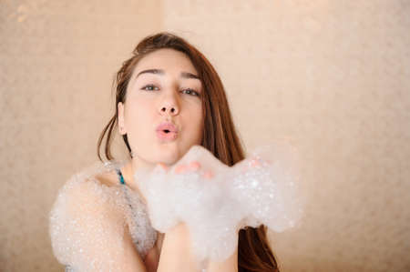 Young woman in white foam in a hamamの写真素材