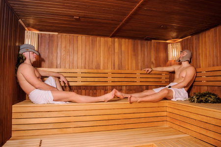 close up photo of 2 men resting in russian saunaの写真素材