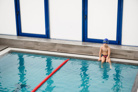 close up photo of a 7-year boy playing and swimming in the swimming pool