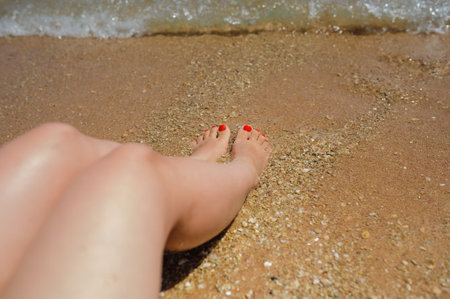 lateral view of woman's legs on the beachの写真素材