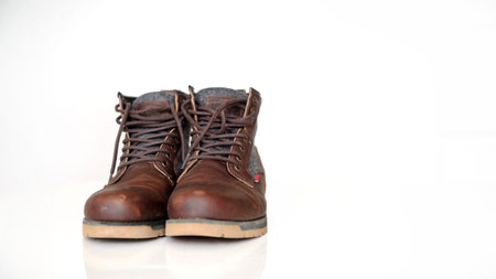 closeup brown autumn boots with laces for men