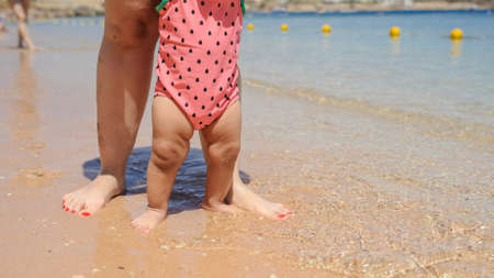 close up photo of father holding in his arms his little baby girl and walking in the garden of a hotel at a tropic destinationの写真素材