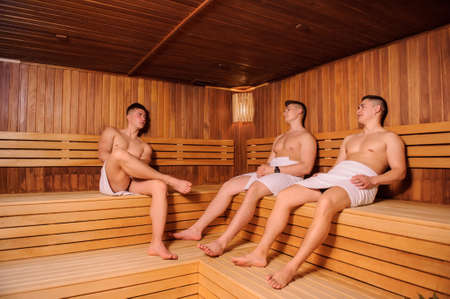 close up photo of 3 men resting in russian saunaの写真素材