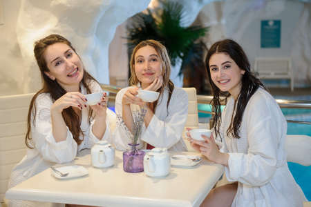 close up photo of young beautiful women drinking tea in the fito bar of a spa salonの写真素材