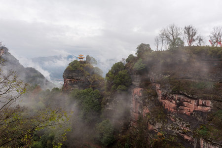 Fog around incense burner at mountain peak