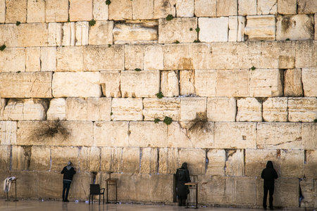People praying in the Western Wall in the old city Jerusalem, Israel Western Wall. Prayers at the...