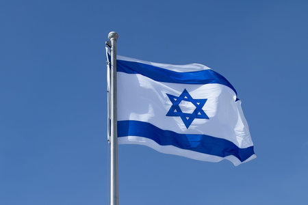 National flag, symbol of Israel in blue and white color blowing in the wind. Flag of Israel waving...