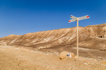 Tourist signs on Golan trails. Hiking markers, hiking trails, way marking, arrow signs. Sign post in the Negev desert in Israel, with blue sky.の写真素材