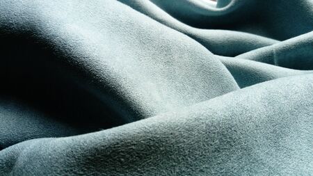 The fabric is gray velvet laid by the waves. Close-up. Lighting is natural.の写真素材