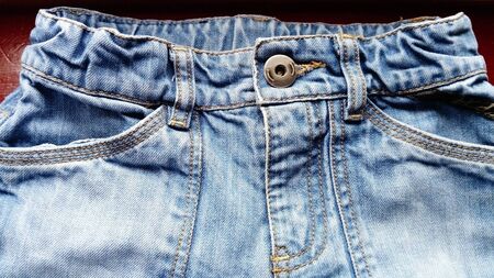 Classic jeans, top of the product. Trousers with two pockets sewn with red thread.の写真素材