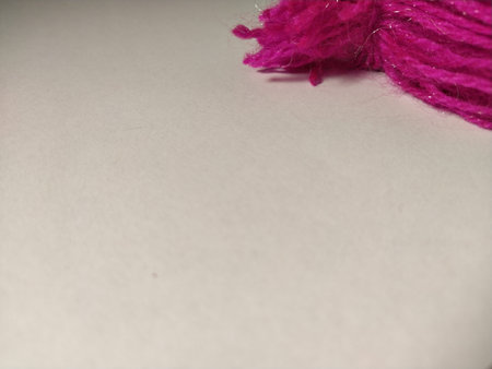 Scarf made of white and pink white threads. Knitwear on a white background. Empty space for text. Soft pastel colors. Winter clothes.の写真素材