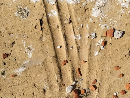Brick or stone close-up. Texture or background. Bright red, brown, orange, beige colors. Dust, small...