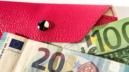 Euro paper notes. European currency on a white background close-up. Wallet or purse in bright pink...