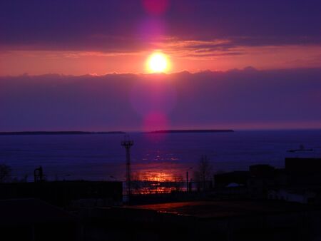 Sunrise in the north. Cloudy morning. Winter sunset on the lake with reflection in the water.の写真素材