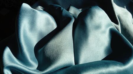 Silk of blue color. Wave Satin Glitter Fabric.の写真素材