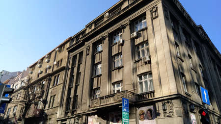 Belgrade, Serbia - January 24, 2020. Street view of an old monumental building. Facade in dark gray tones. Early morning in good weather.のeditorial素材