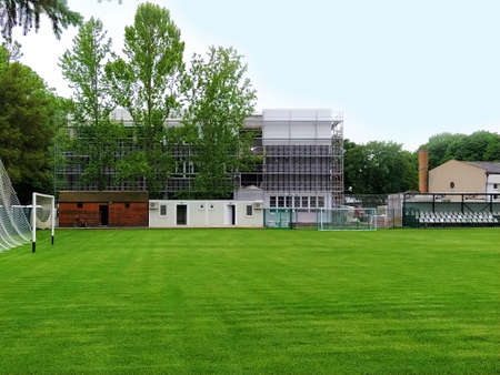 Sremska Mitrovica, Serbia. May 30, 2020. Construction of a new school. School building in scaffolding. Soccer field on the school grounds. Facade work at the final stage of construction.のeditorial素材