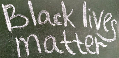 Black lives matter written in chalk on blackboard