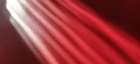 Rays on a red background. Divine glow. Shining glow and sparks