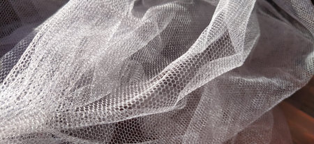 white thin mesh fabric. Fabric for veils, curtains, mosquito nets, tulle and other products of light...