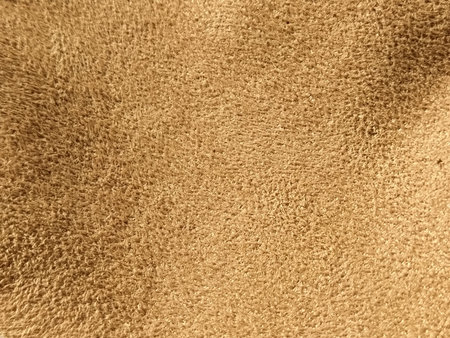 beige suede fabric. Close-up of a faux suede or nubuck fabric. Sewing accessories and fabrics. Short pile textureの写真素材
