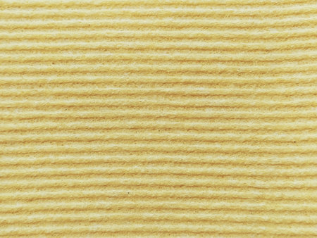 Close-up of a striped fabric with raised printing. Horizontal stripes on yellow microfiber or...