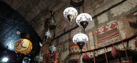 Traditional vintage Turkish lamps over light background in the night. Colored glass lamps and shades...