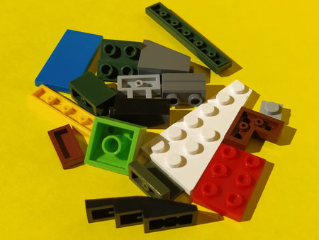 Childrens plastic designer or constructor. Details, geometric shapes on yellow background. Flat lay,...