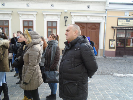 Szentendre, Budapest, Hungary, 8 March 2018. Tourists visiting the sights of Saint Endre in Hungary, Budapest. People in warm clothes stand and look at the guide. Guided tour of the old town. March in Hungaryのeditorial素材