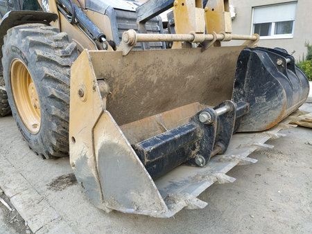 Bucket from a grader, bulldozer or excavator. Land, construction and road works. Wheel, car body and...