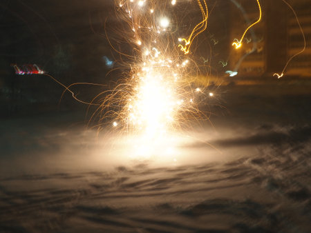 fireworks in the night sky. Colorful flashes of fire on black background. Celebration, festival or victory symbol. Explosions of fire and sparks in the sky. Flying colored zigzags, stripes and curlsの写真素材