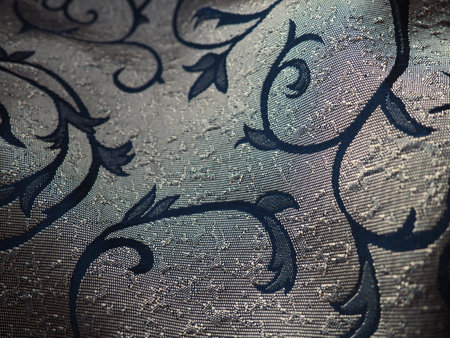 silk blue fabric with golden curls. Textiles for upholstery, curtains and festive clothing. The fabric is softly folded in wavesの写真素材