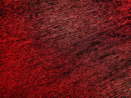 Corrugated paper in red. Uneven surface. Abstract background. Wavy edges of the paper sheet. Lighting gradient.の写真素材