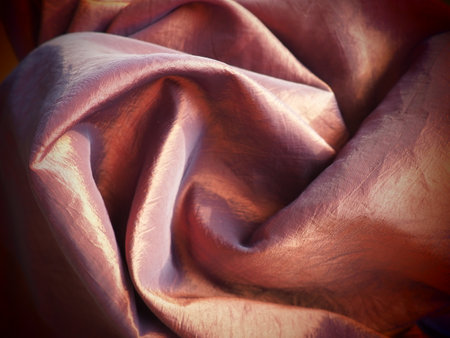 Beautiful fabric - taffeta, gently folded in waves. Crumpled material that looks like silk or brocade. Overflow and color gradient at different lighting angles. Fabric for sewing clothes and curtains.の写真素材