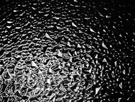 beautiful corrugated glass with a light and dark background. reflections of light.の写真素材