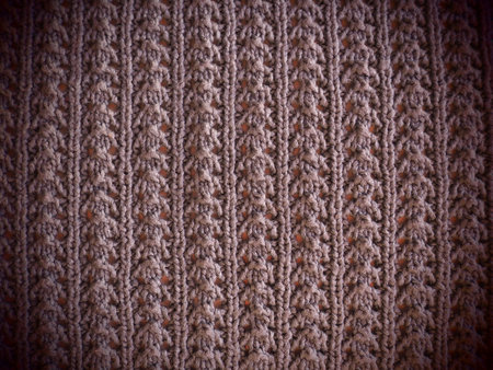 knitted pattern of pink or red yarn. Lush machine or hand knitting. Warm wardrobe for the autumn-winter period. Knit with front, purl loops. Knitting method - wavy elastic.の写真素材