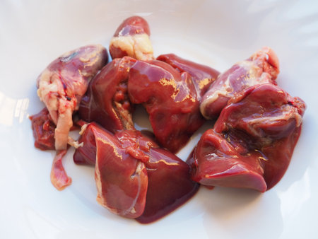 raw chicken liver, kidneys and heart. Poultry entrails and offal, prepared for cooking. A diet high...
