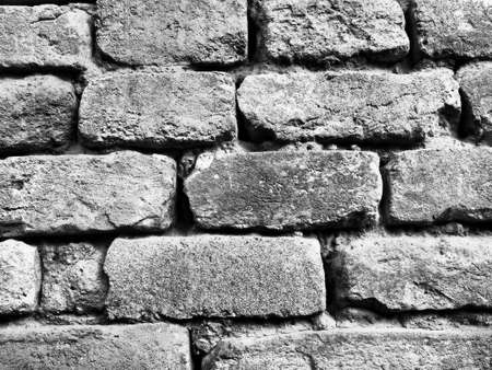 Gray brick wall. Retro and vintage style. High-grain monochrome black and white image.の写真素材