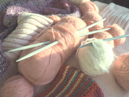 Tangles, snarls. Balls of yarn and thread, knitted clothes, knitting needles and crochet hooks....