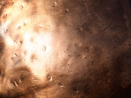 Metal bronze textured plate. Bronze or copper polished surface with dents, scratches and indentations. Metal texture.の写真素材