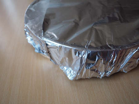 Texture of crumpled aluminum foil for baking. Food foil on a baking sheet before placing in the oven.の写真素材