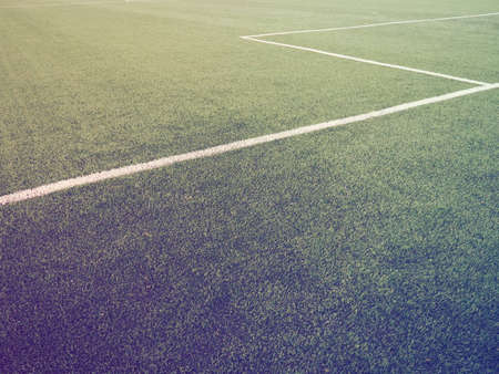 The marking of the football field on the green grass. White lines no more than 12 cm or 5 inches wide. Football field area. Side lines, goal lines. Sun glare. Color and light gradient.の写真素材
