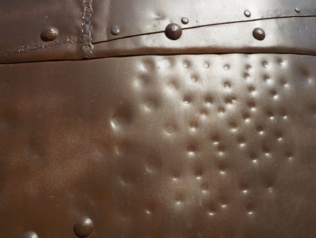 Metal surface with rivets and bolts. Abstract background of a military or industrial nature....