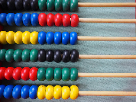 Education concept - abacus with many colorful beads. Red, blue, green, black, yellow details on the...