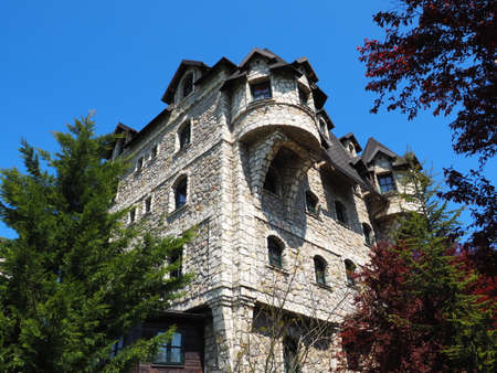 Stanisici, Bijelina, Republika Srpska, Bosnia and Herzegovina April 25 2021 Ethno village, tourism and attractions. Stone and wooden buildings of the hotel. People visit restaurant, traditional housesのeditorial素材
